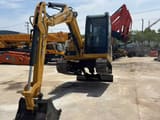 2024 Caterpillar 305.5E excavator, front three-quarter view
