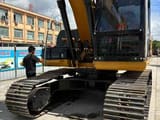 2024 Caterpillar 320D2 crawler excavator, rear three-quarter view