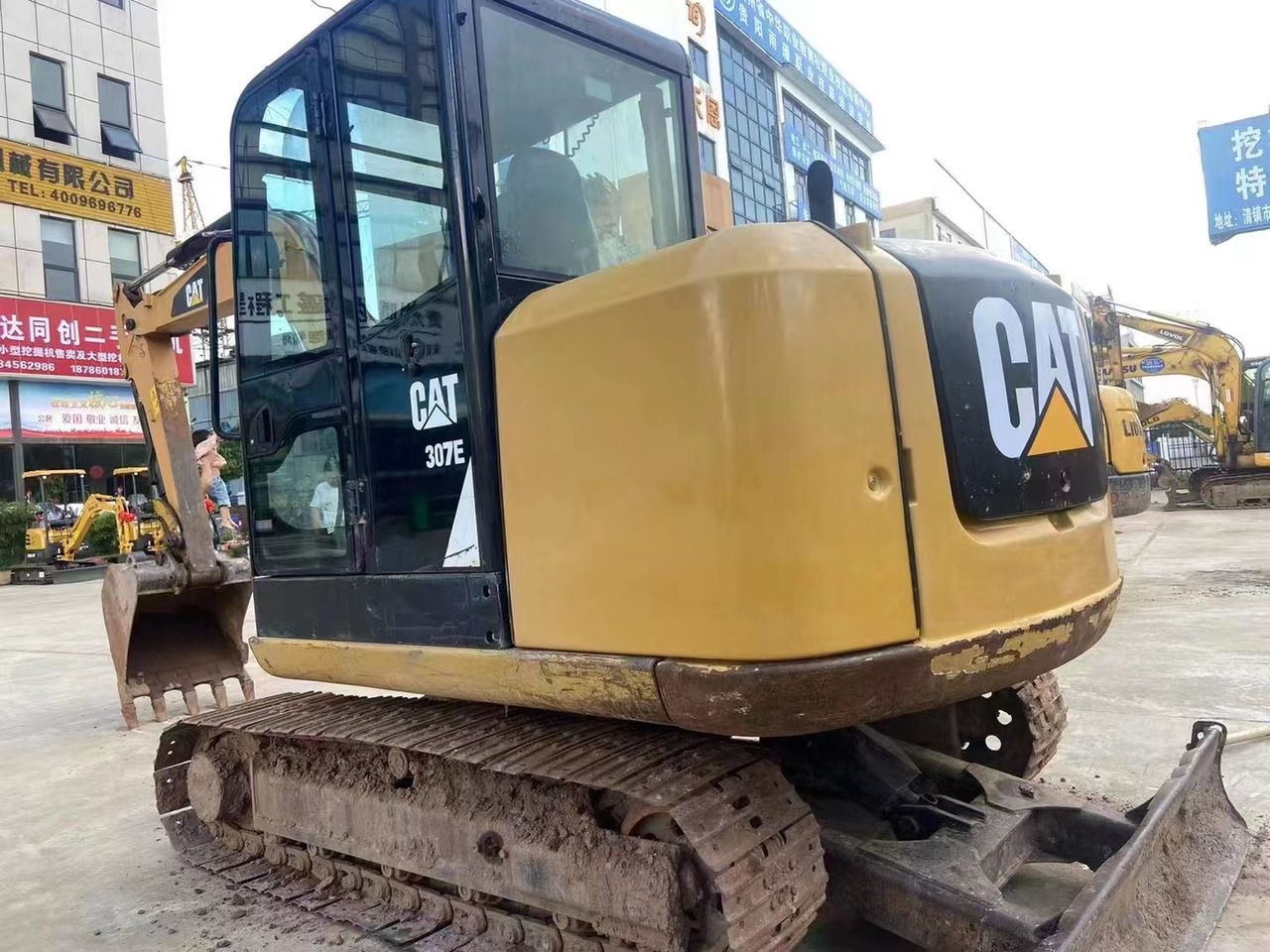 2022 Caterpillar 307E excavator, rear three-quarter view