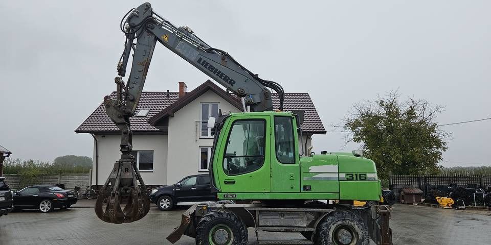 2011 Liebherr A316 LITRONIC wheel excavator side view 2011 Liebherr A316 LITRONIC wheel excavator side view