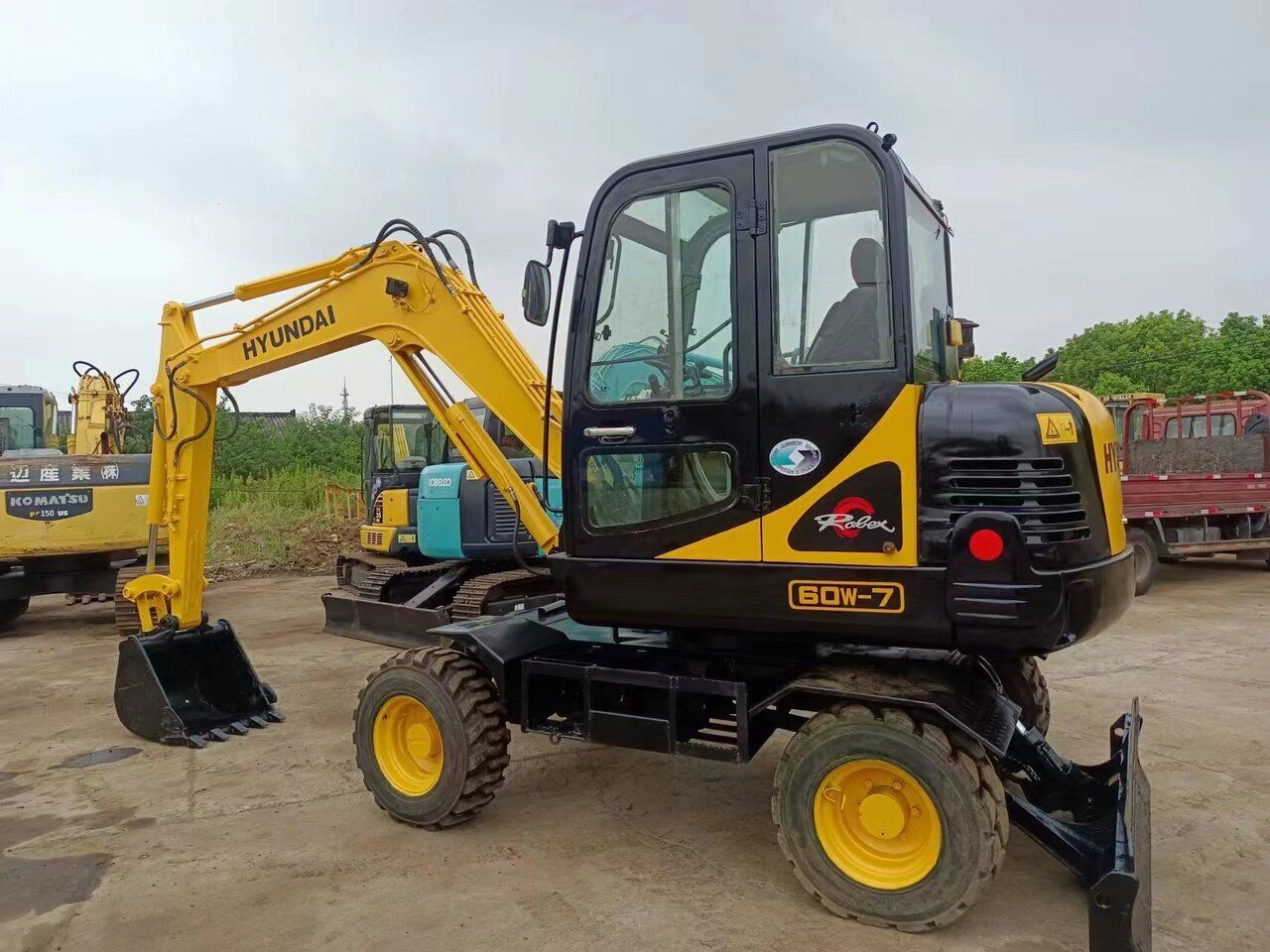 2016 Hyundai 60W-7 wheel excavator, side profile view