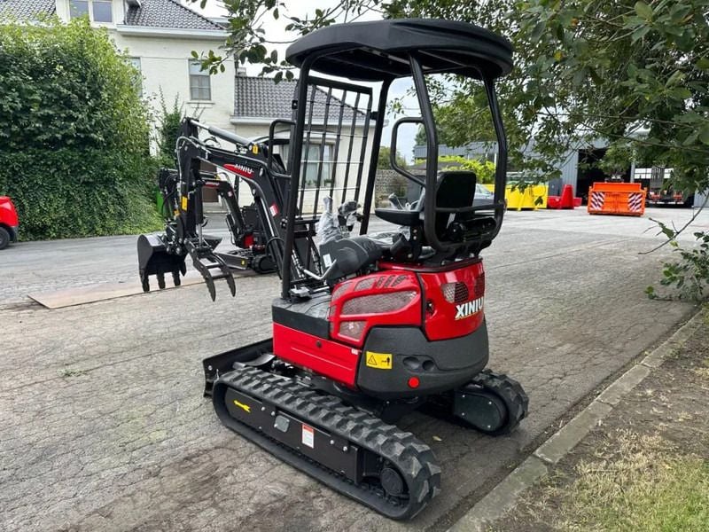 2025 Rhinoceros XN18 Mini Excavator with a red body and a black canopy over the operator station. 2025 Rhinoceros XN18 Mini Excavator with a red body and a black canopy over the operator station.