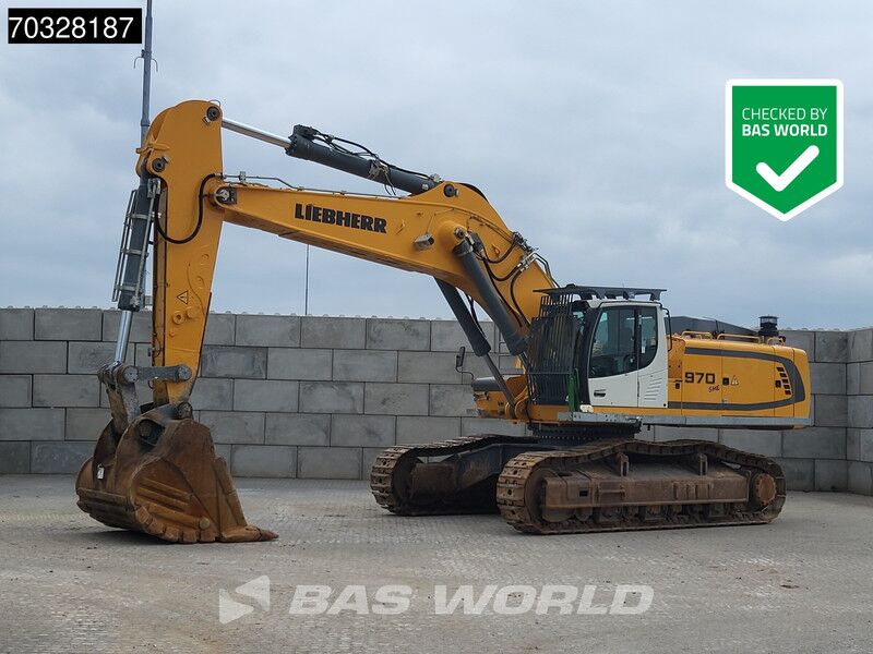 2018 Liebherr R 970 S HD crawler excavator, yellow boom extended with a worn digging bucket resting on its cutting edge 2018 Liebherr R 970 S HD crawler excavator, yellow boom extended with a worn digging bucket resting on its cutting edge