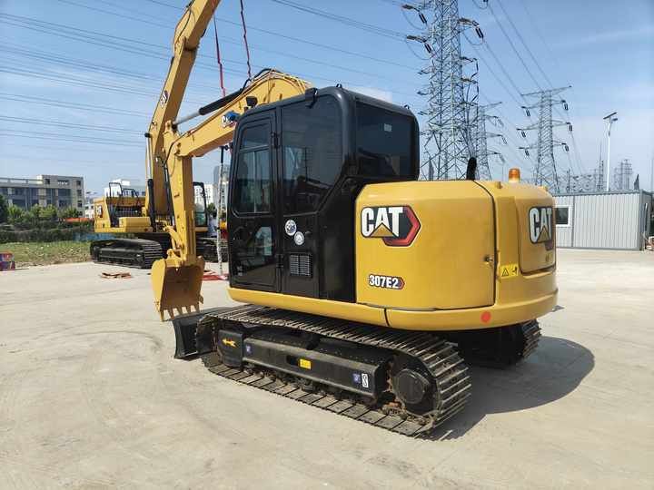 2023 Caterpillar 307E2 excavator, rear three-quarter view