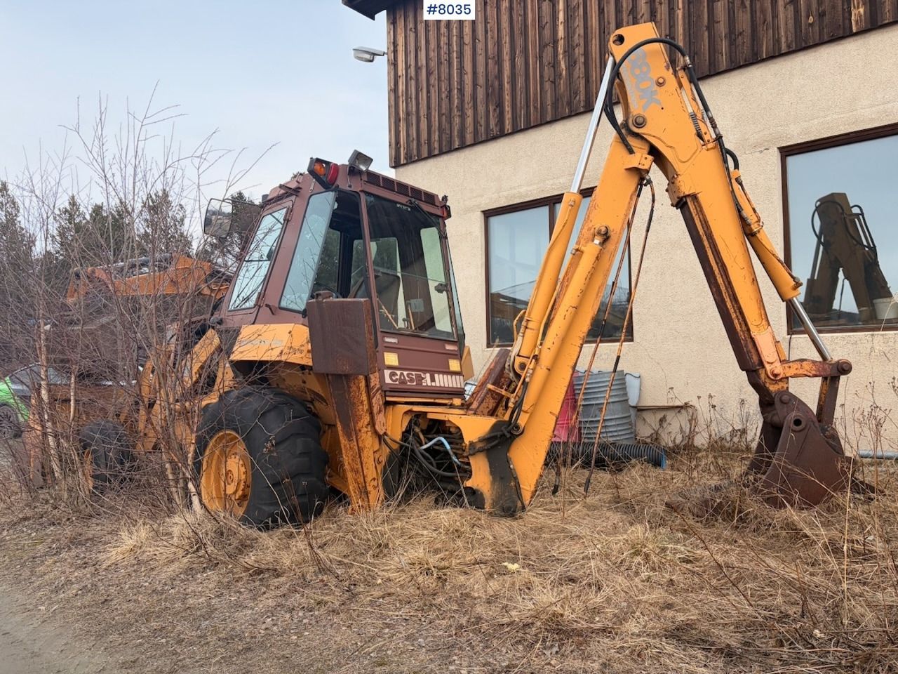 1988 CASE 680K backhoe loader, side view