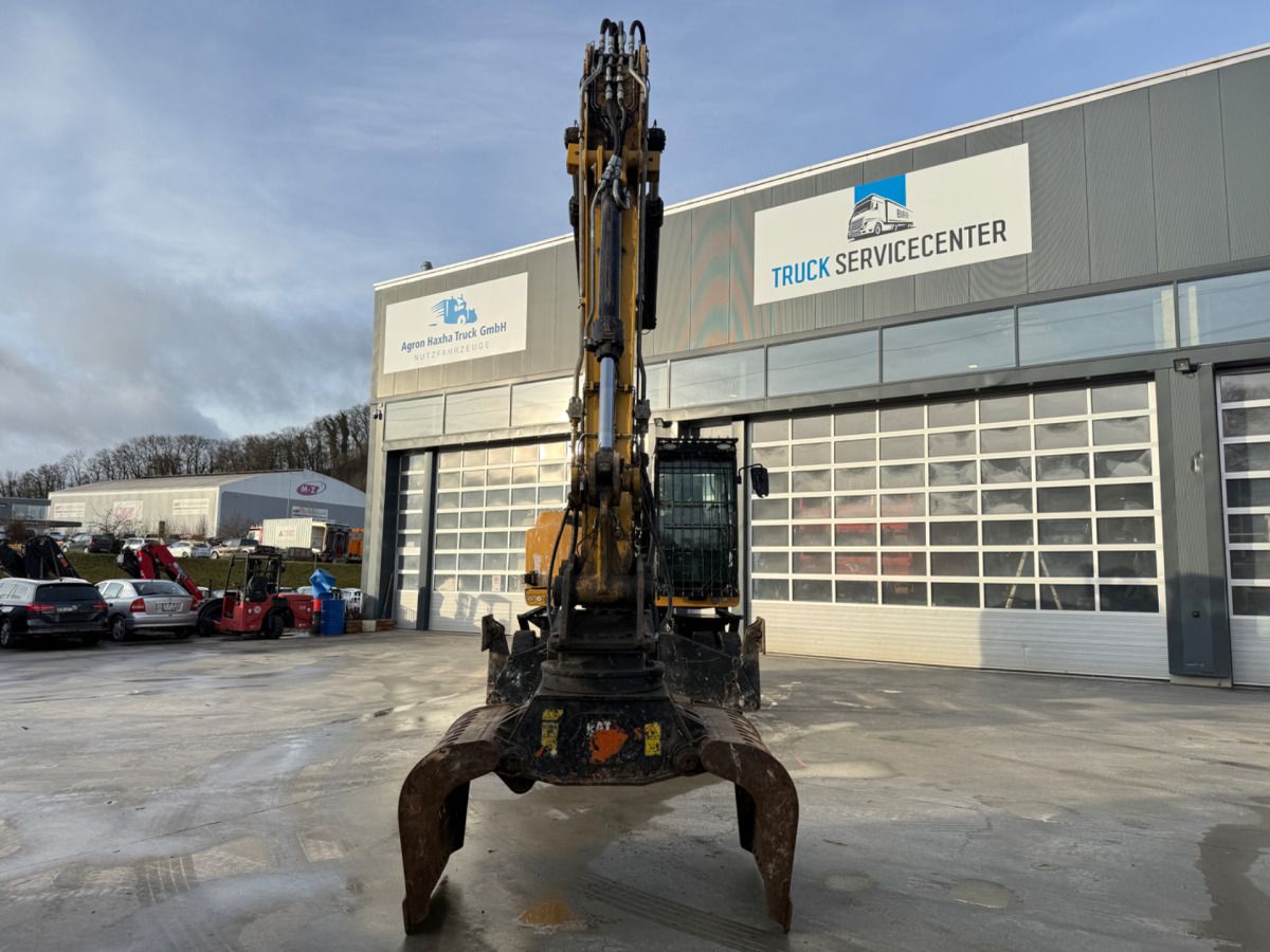 2016 Caterpillar MH3022 wheel excavator, front view with grapple attachment