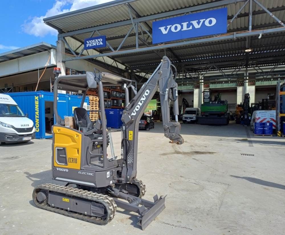 2022 Volvo JECR18E Mini Excavator with a gray boom and arm extended to the front, showing the bucket attachment. 2022 Volvo JECR18E Mini Excavator with a gray boom and arm extended to the front, showing the bucket attachment.