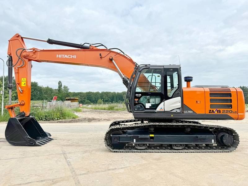 2025 Hitachi ZX220 Crawler Excavator with orange boom and black digging bucket in a side view. 2025 Hitachi ZX220 Crawler Excavator with orange boom and black digging bucket in a side view.