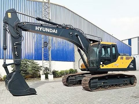 2025 Hyundai R215 Crawler Excavator with a dark gray boom and arm extended forward, showing the bucket attachment. 2025 Hyundai R215 Crawler Excavator with a dark gray boom and arm extended forward, showing the bucket attachment.